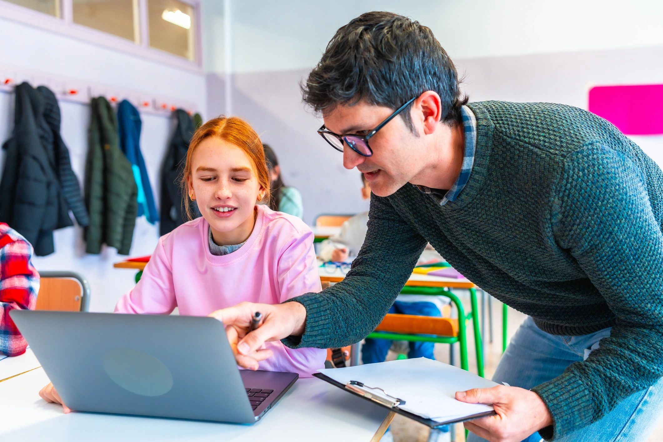 teacher helping students